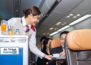Air hostess assisting passenger with wheelchair and luggage inside an international airplane cabin
